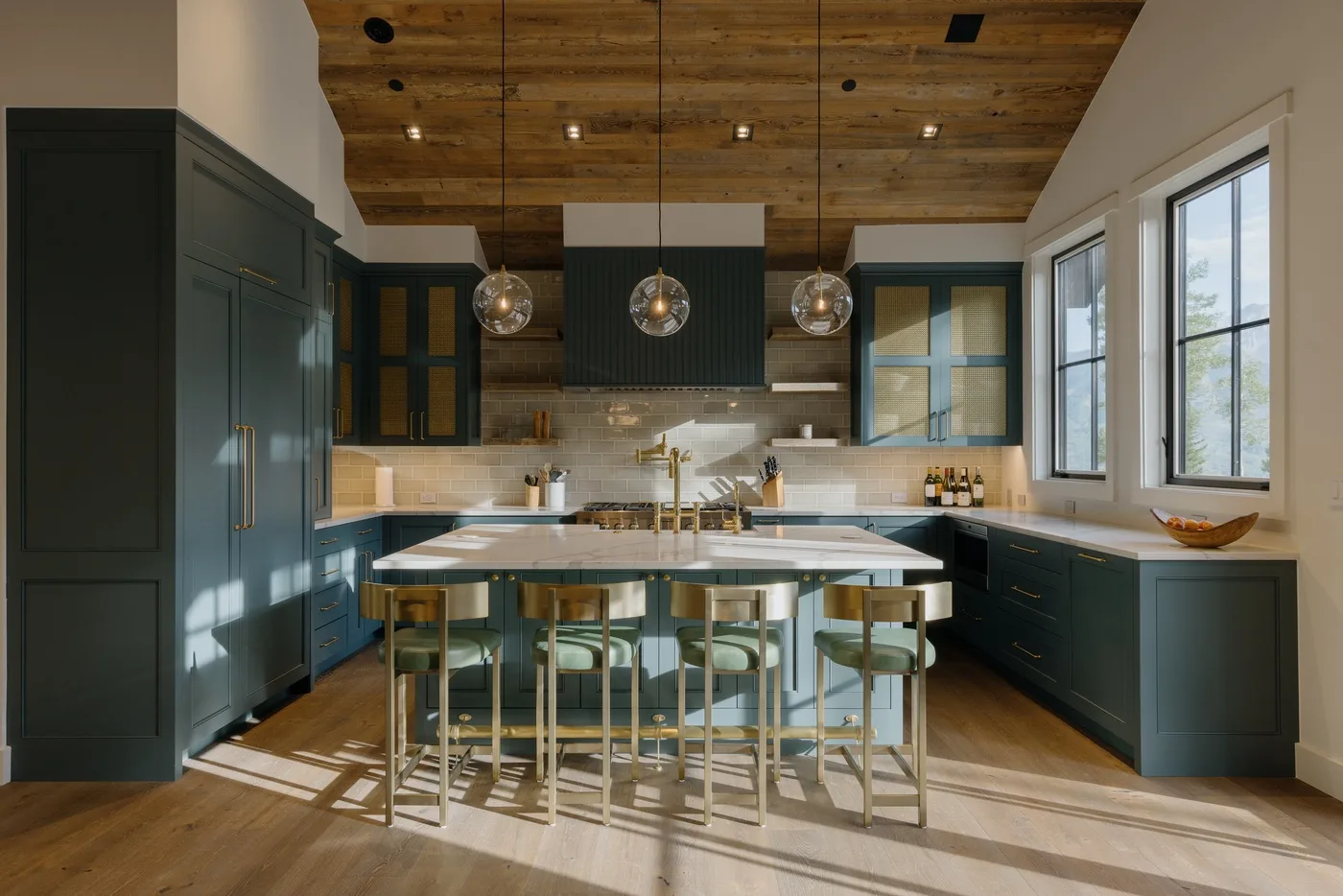 A spacious kitchen with dark cabinetry, a central island, and pendant lights.