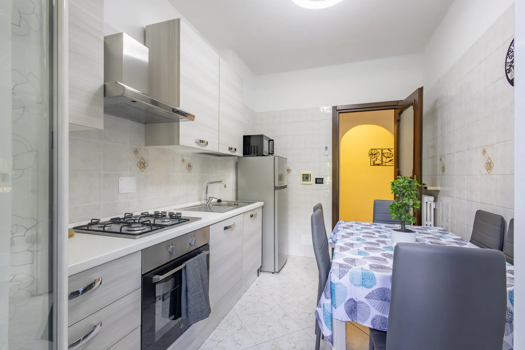 A bright kitchen and dining area with a table beside the counter.