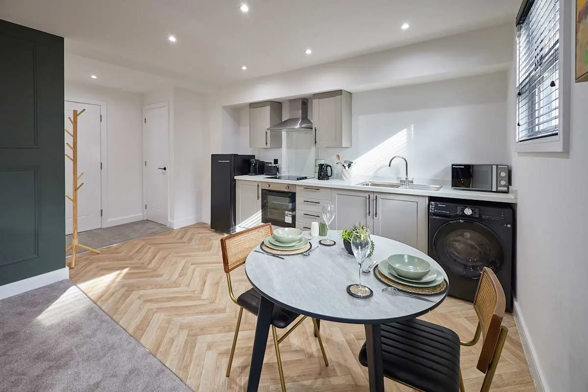 Una cocina luminosa con una mesa junto a la encimera.