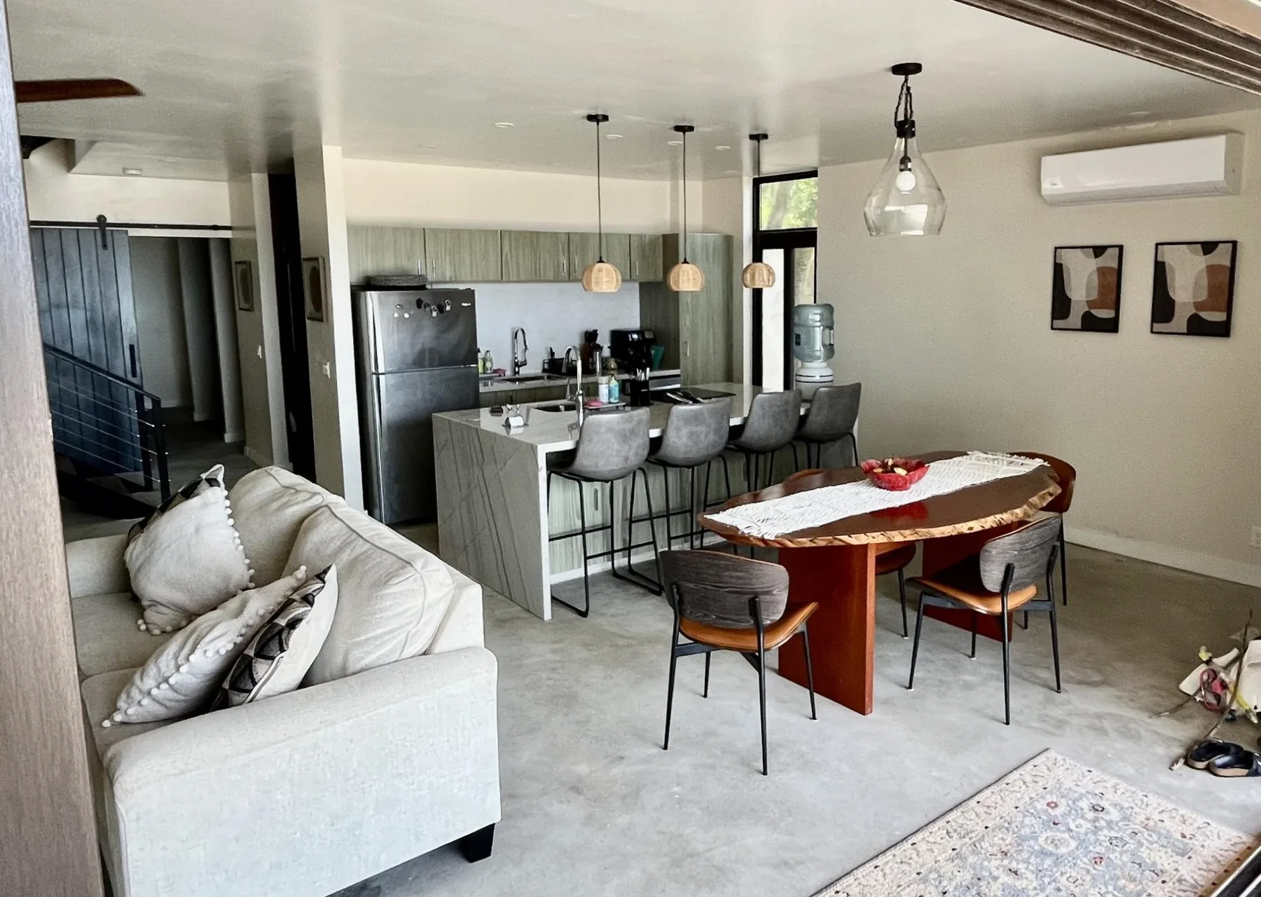 An open-plan living and dining area with a kitchen island and table.