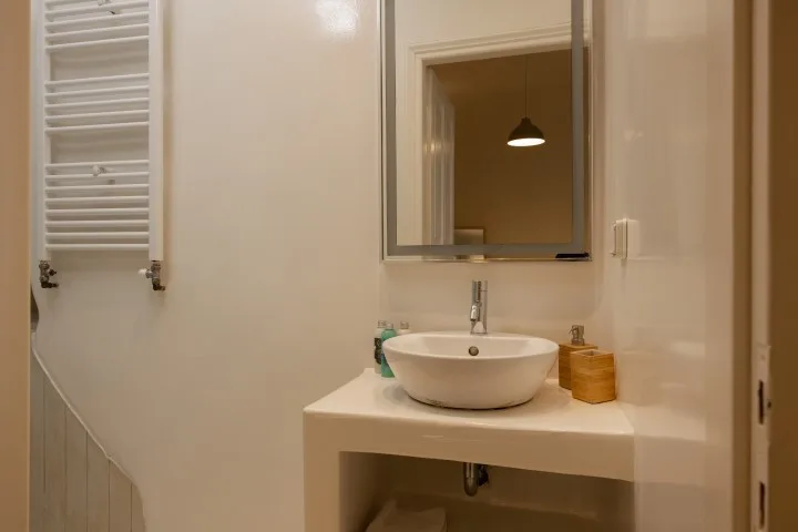 A bathroom vanity with a sink and mirror.