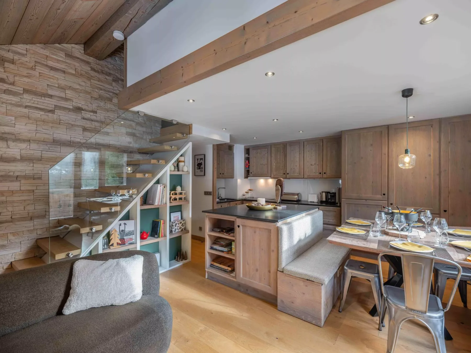 Open-plan kitchen and dining area with a central island and wood cabinetry.
