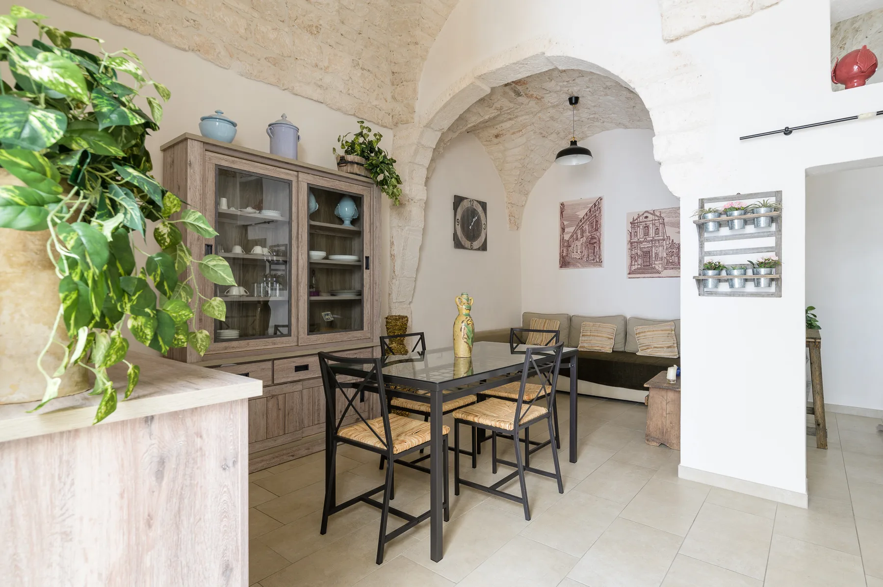 A dining area with a table, seating, and a glass-front cabinet.