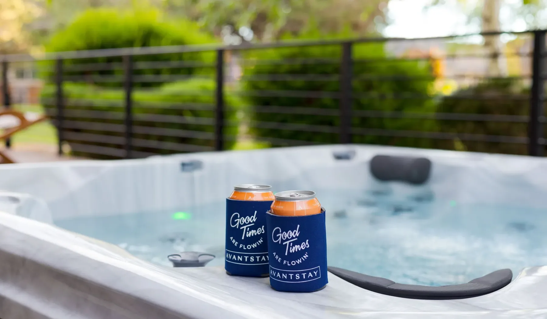 An outdoor hot tub with two drink cans resting on its edge.