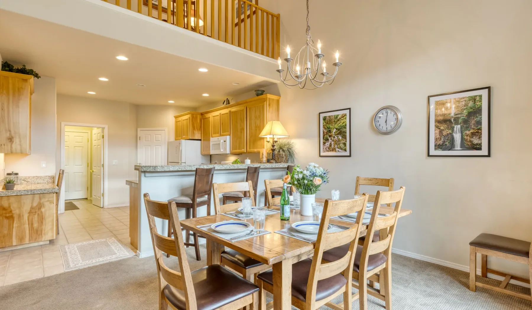 An open dining area with a wooden table beside the kitchen.