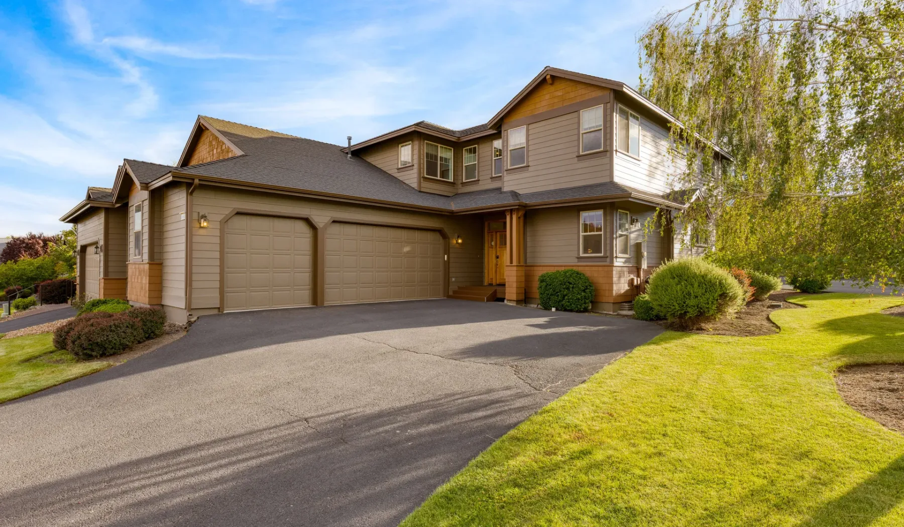 A two-story house with a wide driveway and attached garage.