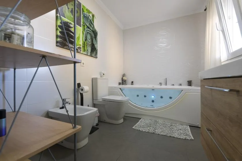 A bathroom with a bathtub, toilet, and sink.