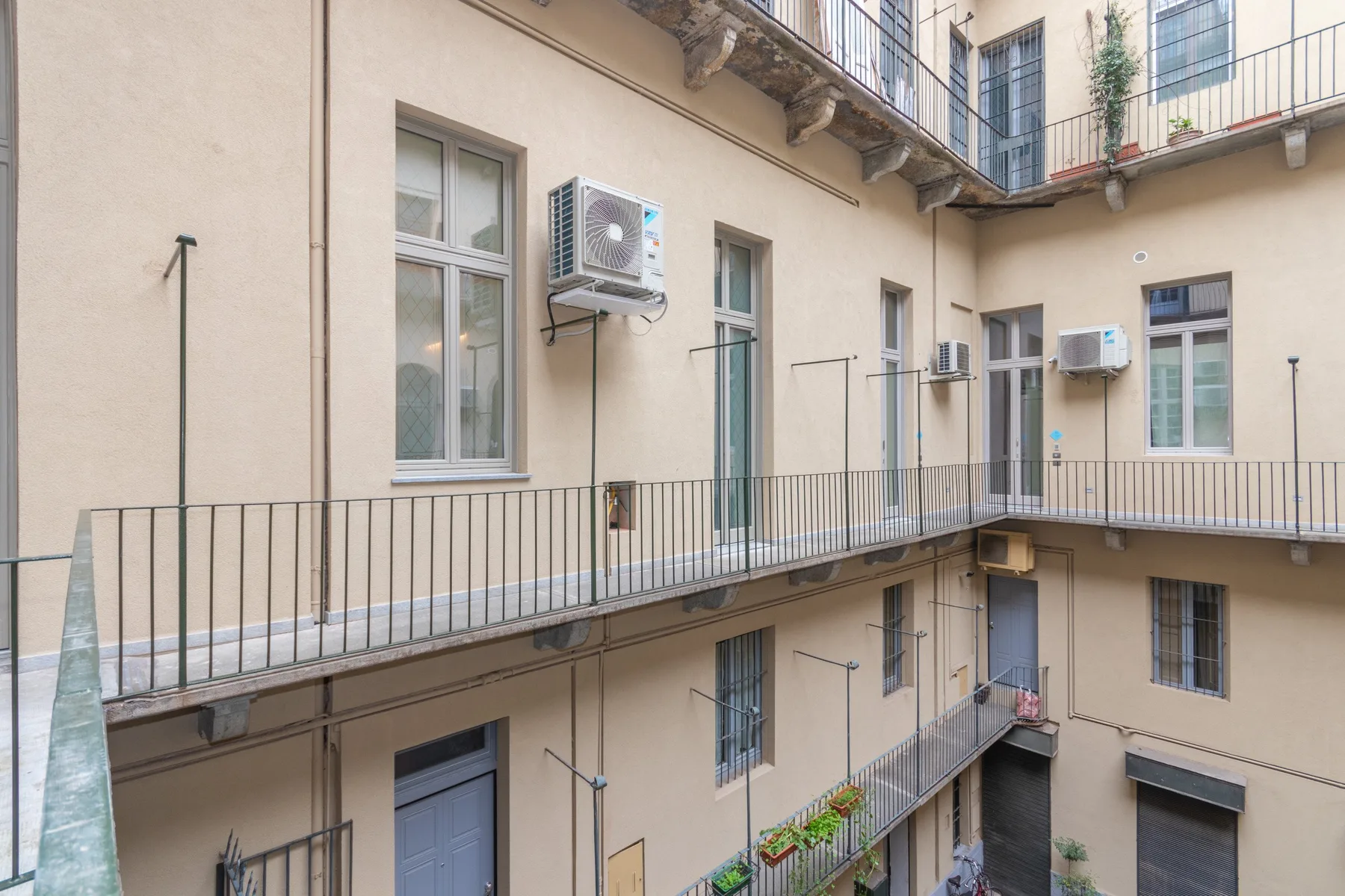An open courtyard with balcony walkways along the surrounding building.