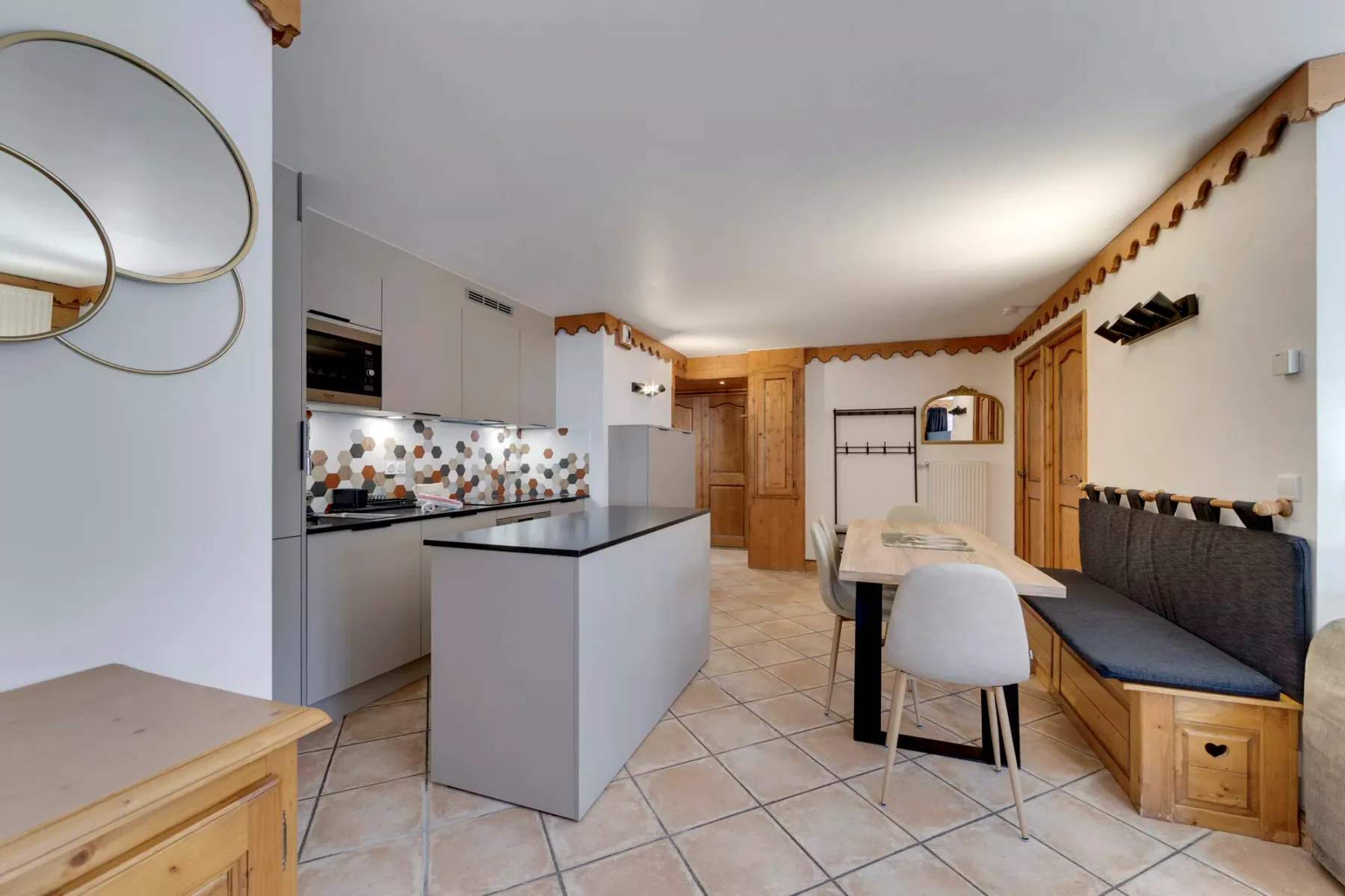 A kitchen and dining area with a central island and built-in bench seating.