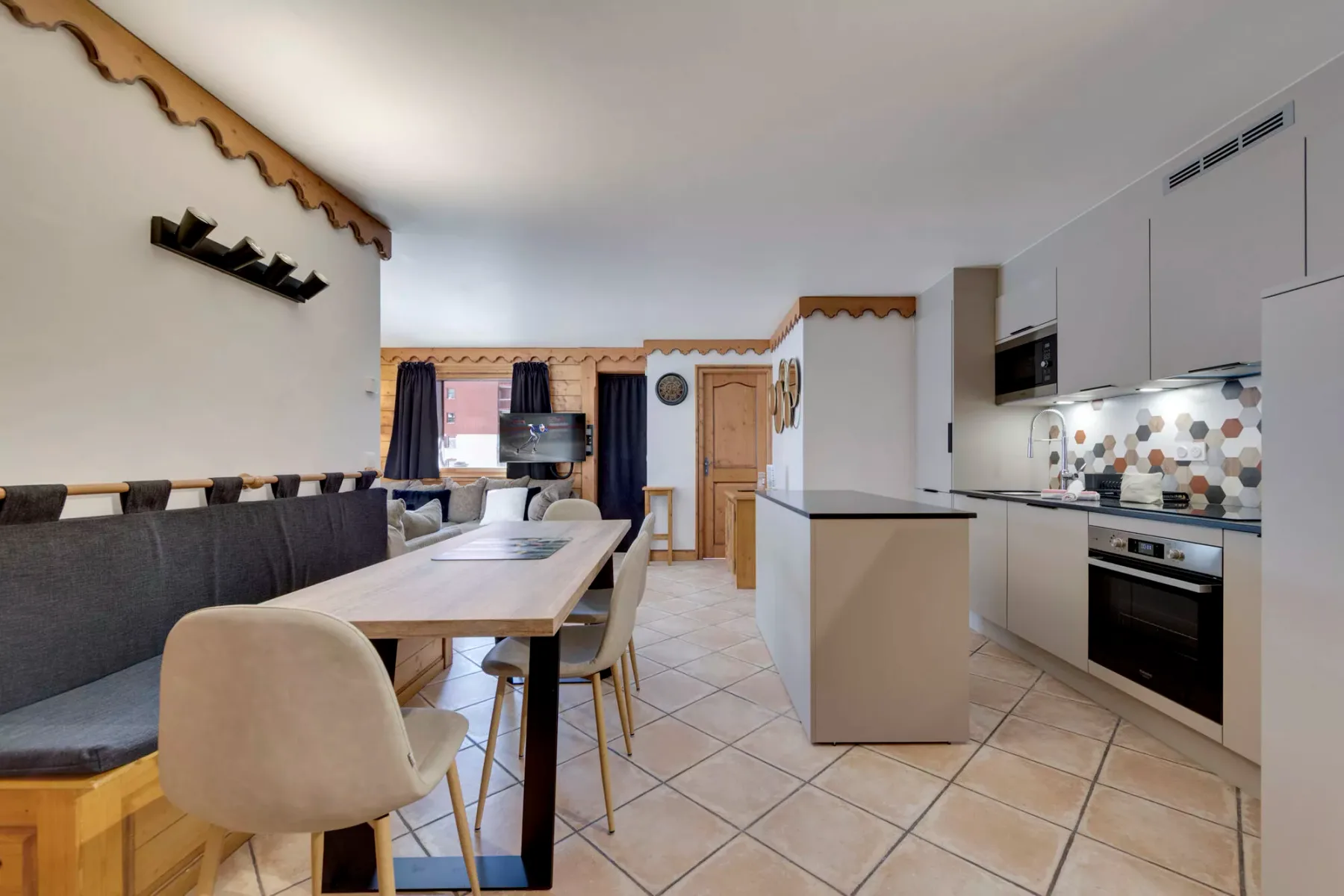 An open-plan kitchen and dining area with a table beside the kitchen counter.