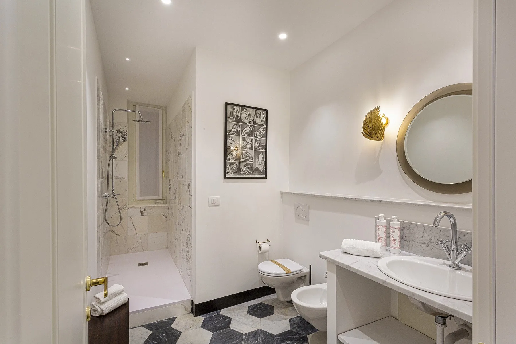 A bright bathroom with a walk-in shower, toilet, and sink.