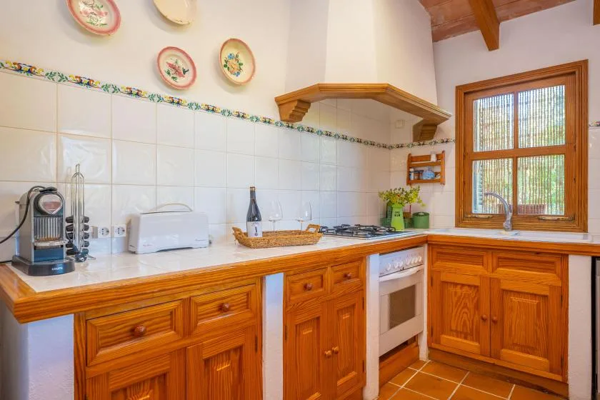 A kitchen with wooden cabinets, a countertop, and a window.