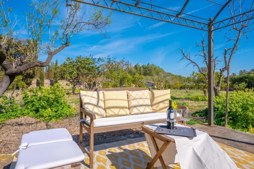 An outdoor patio seating area with a table and surrounding trees.