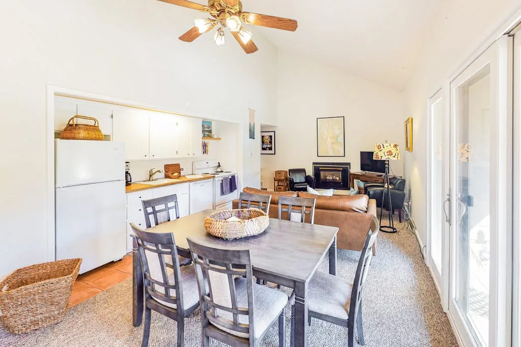 A combined kitchen and dining area with a table and seating.