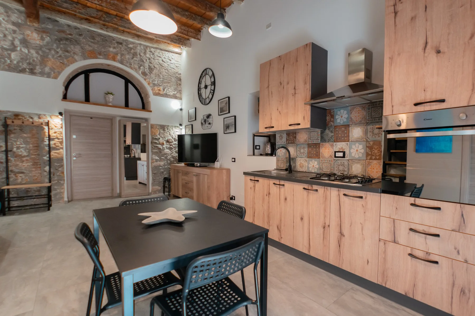 A kitchen and dining area with wooden cabinets and a dark dining table.
