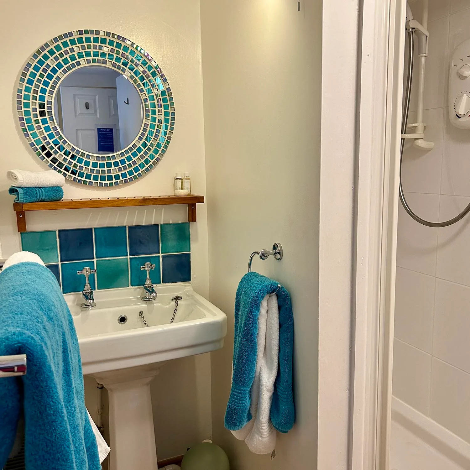 Samphire en-suite shower room with turquoise tiles and towels