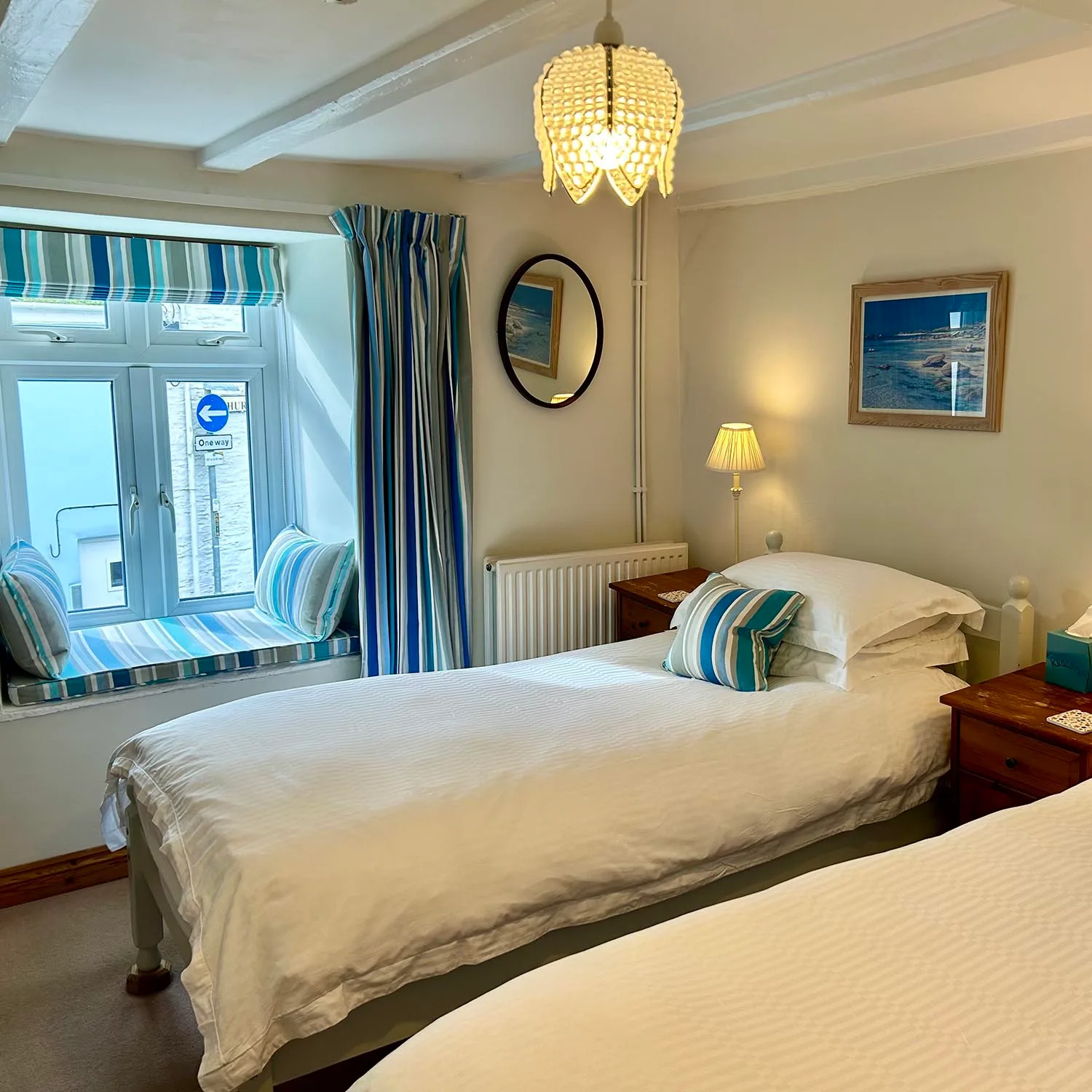 Samphire twin bedroom with two single beds and blue striped furnishings