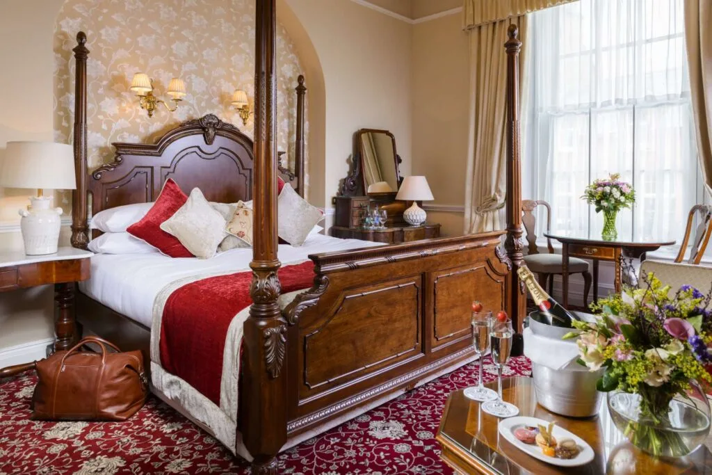Guest room with a wooden four-poster bed.