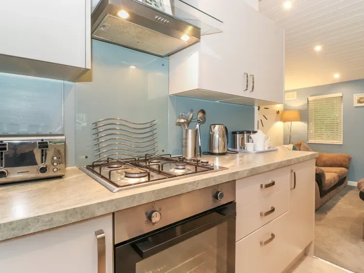 A modern kitchen with a gas cooktop and countertop appliances.