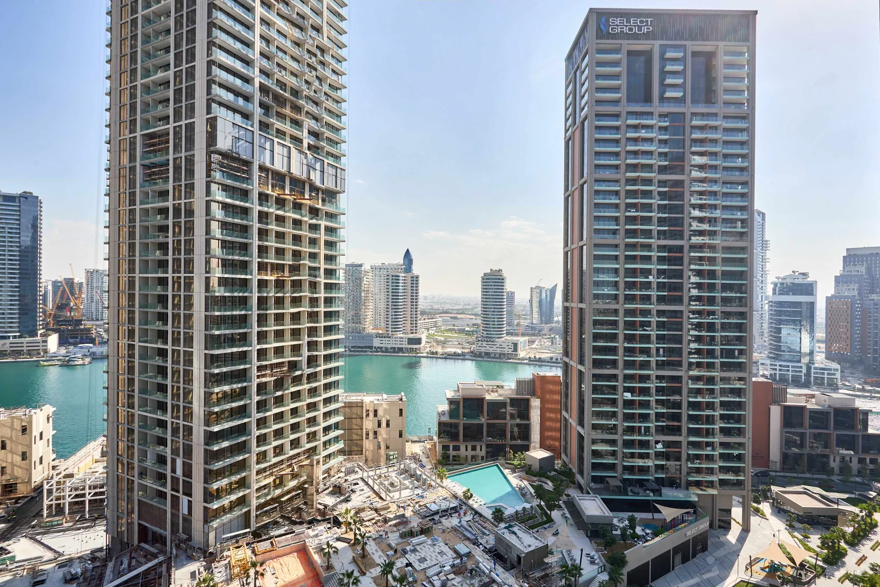 A city skyline of modern high-rise buildings beside a waterfront.