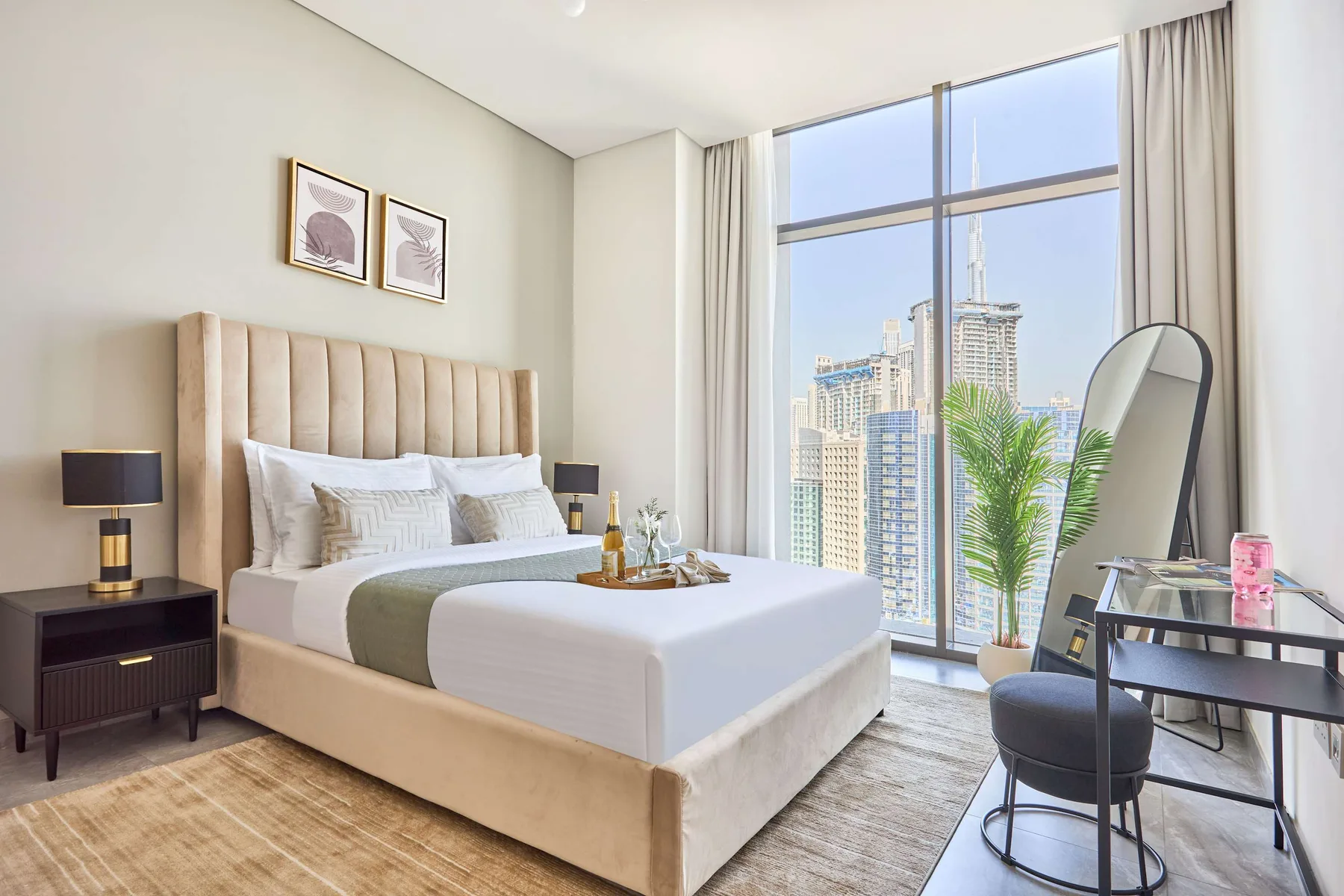 A bedroom with a neatly made bed beside a large window.