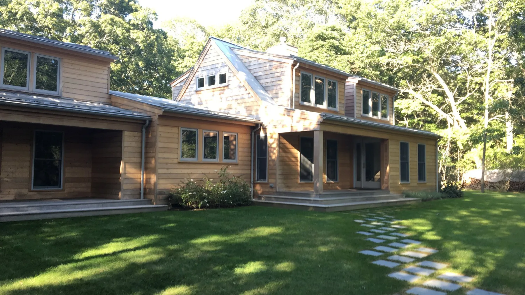 A modern house with a broad lawn and a stepping-stone path.