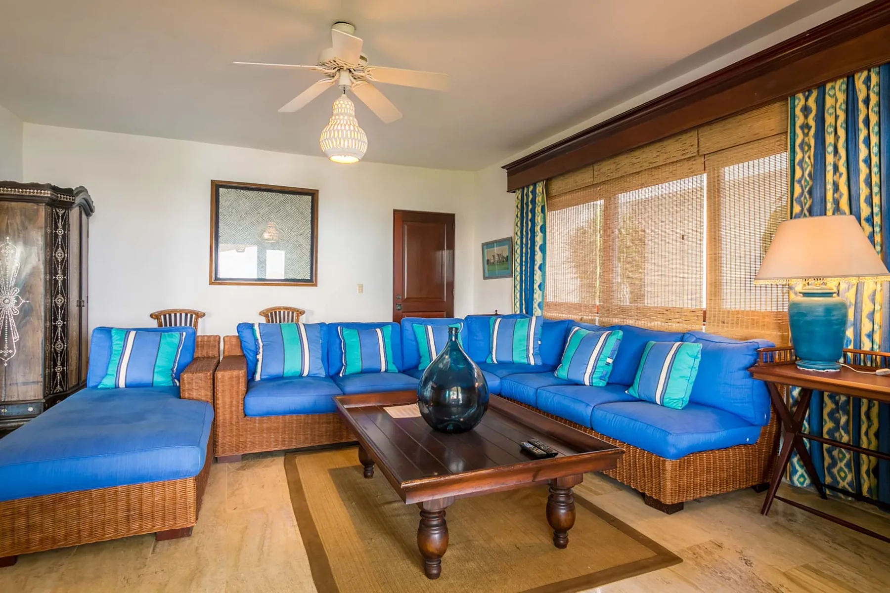 A living room with blue seating arranged around a wooden coffee table.