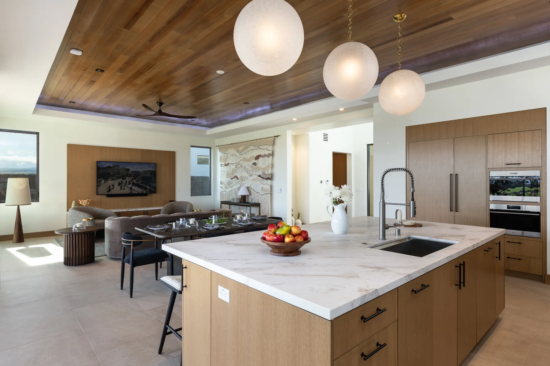 An open-plan kitchen with a large island and a living area beyond.