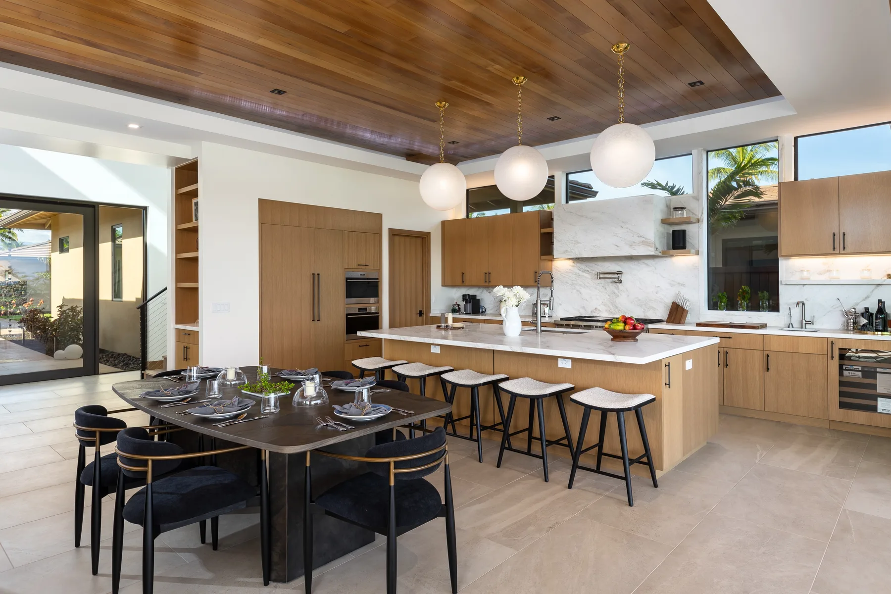 A modern kitchen and dining area with a large island and dining table.
