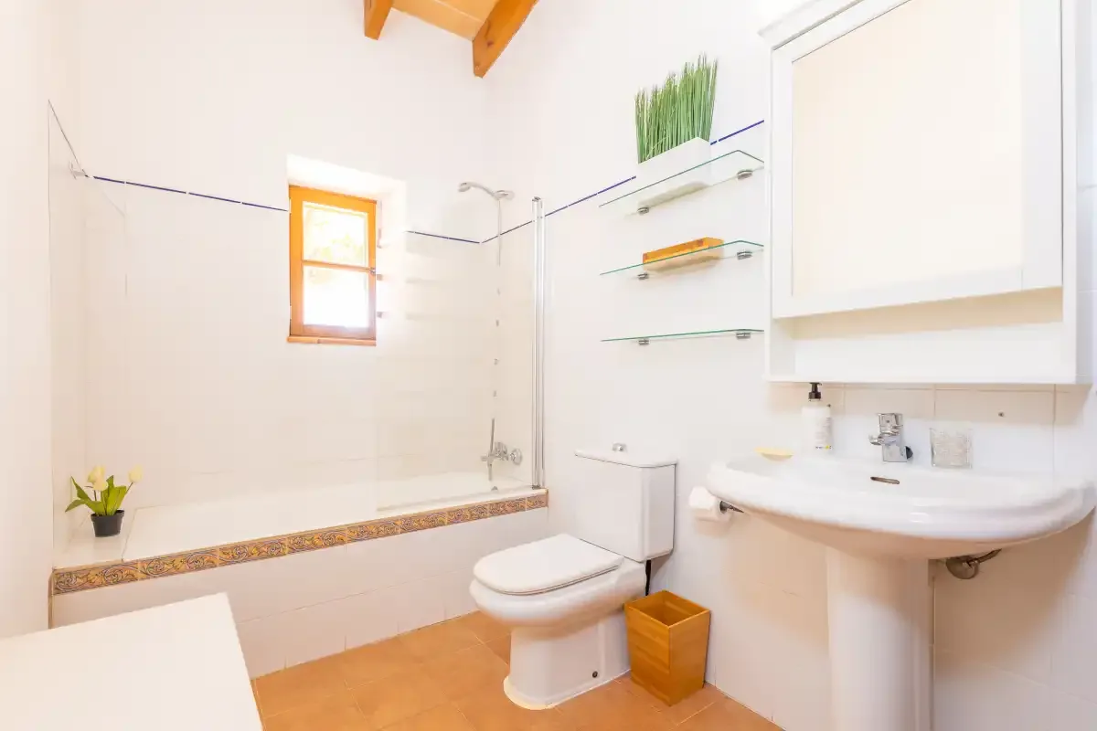 A bright bathroom with a bathtub, toilet, and sink.