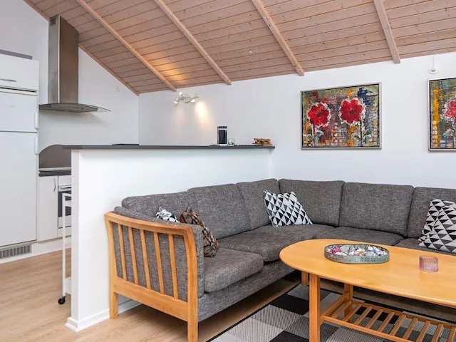A living room with a gray sectional sofa and a wooden coffee table.