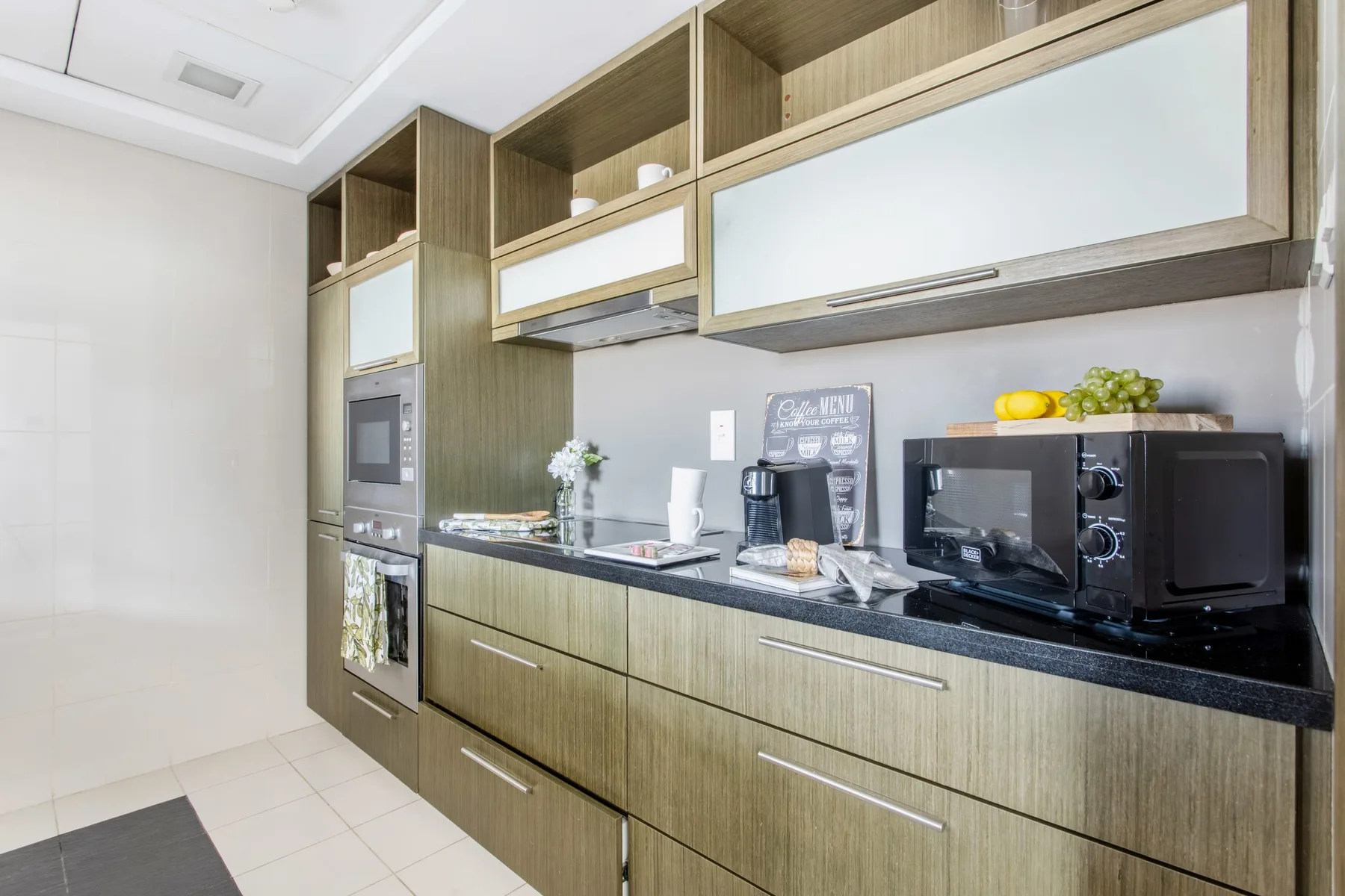 A modern kitchen with wood cabinetry and countertop appliances.