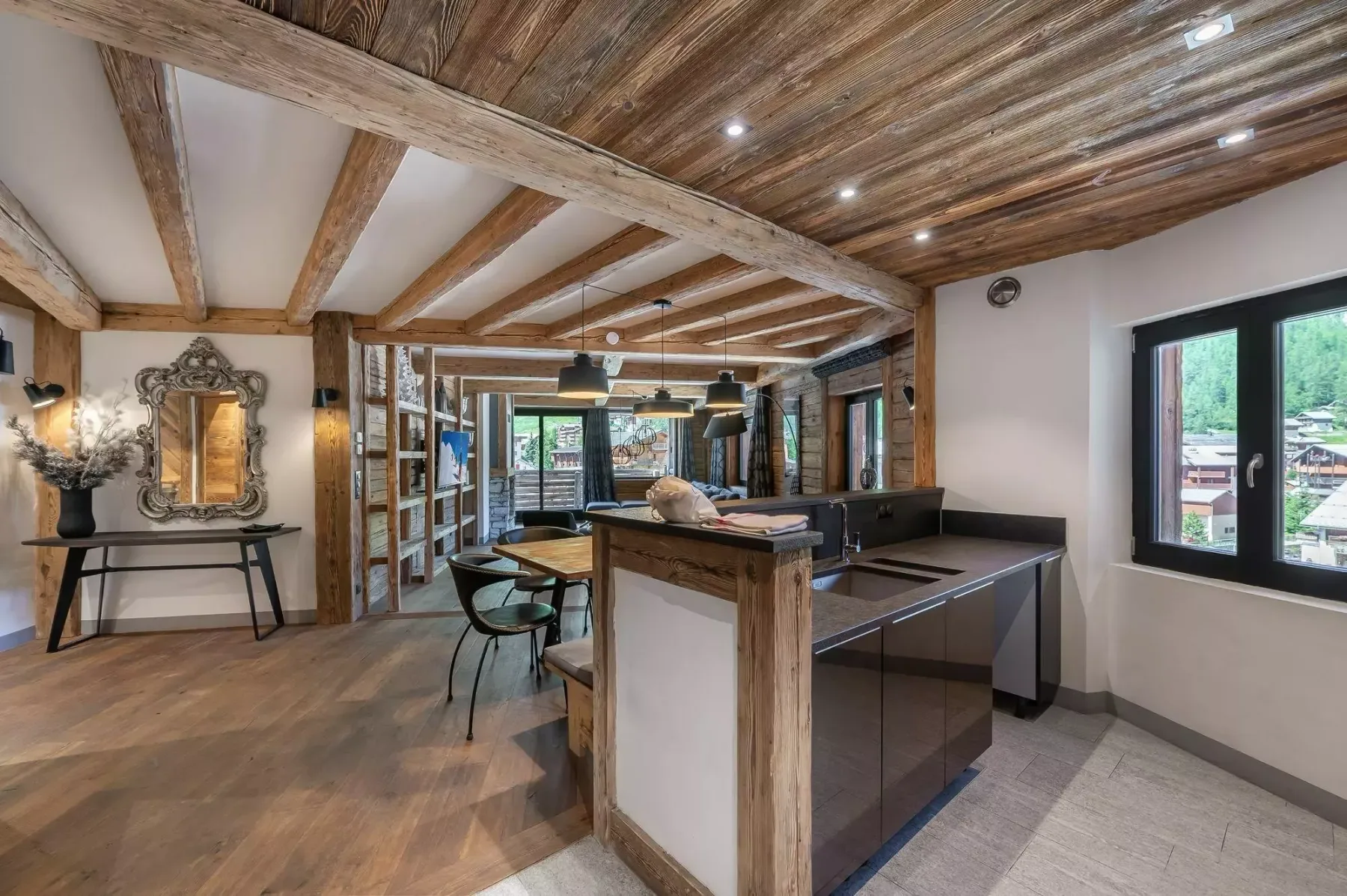 Open-plan kitchen and dining area with a wooden ceiling and island.