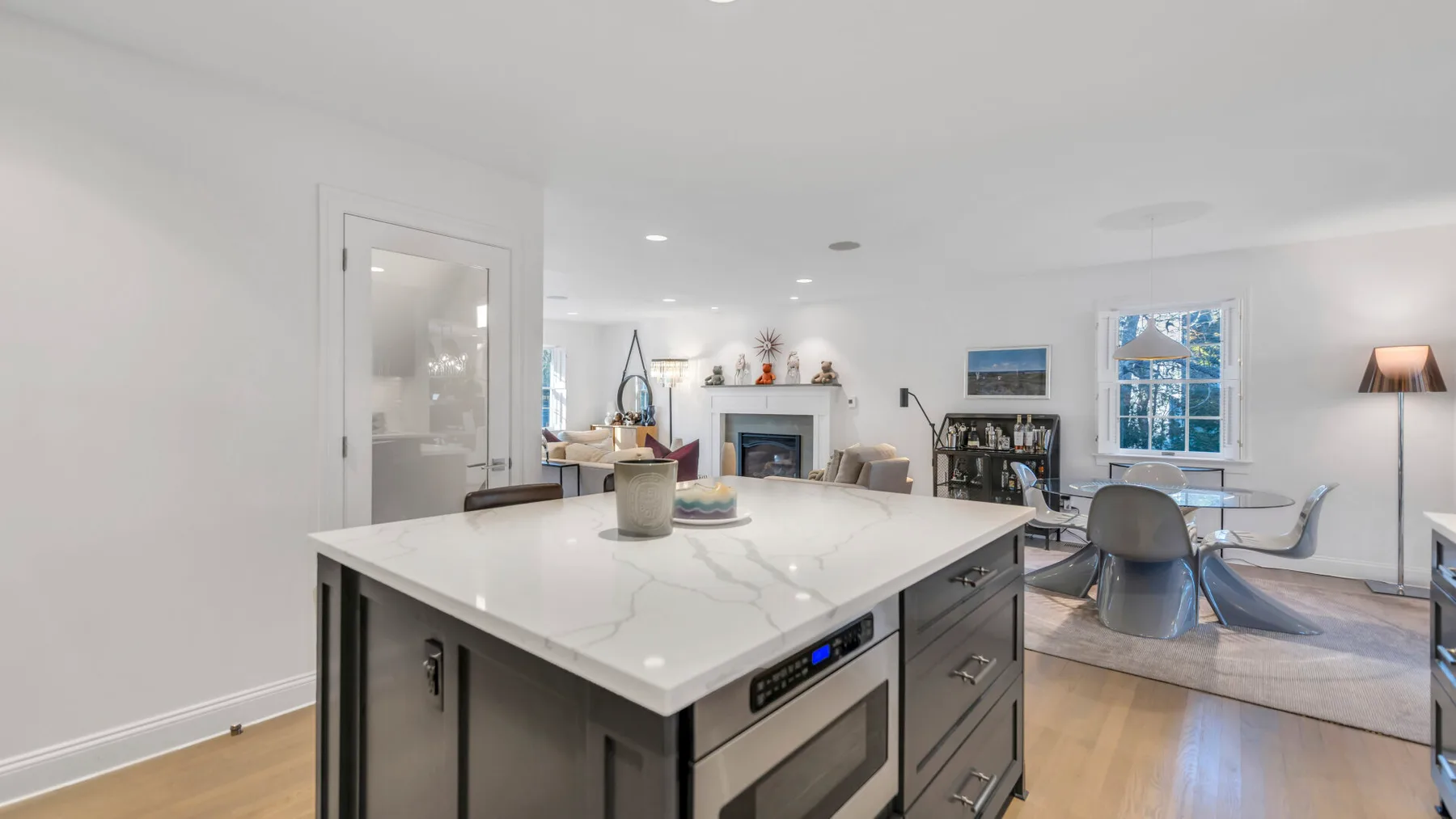 A bright open-plan kitchen and dining area with a large island and seating.