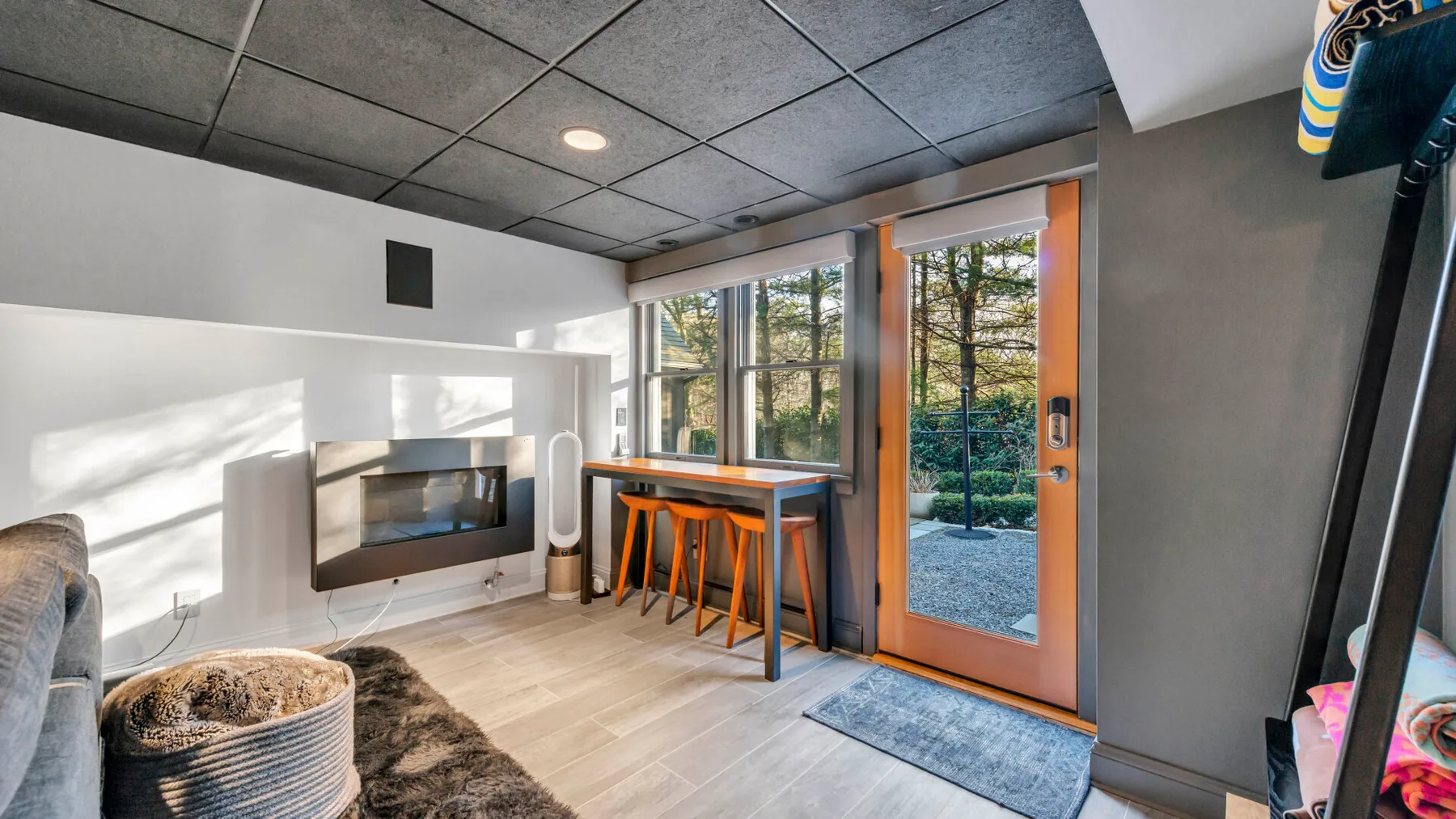 A bright living area with a built-in fireplace and a dining table by the glass doors.