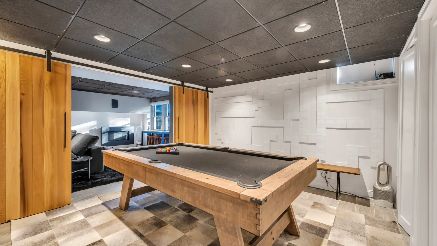 A game room features a pool table and wooden sliding doors.