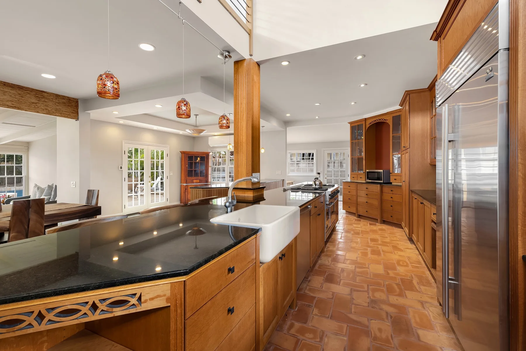 A spacious kitchen with wooden cabinets, a central island, and stainless steel appliances.