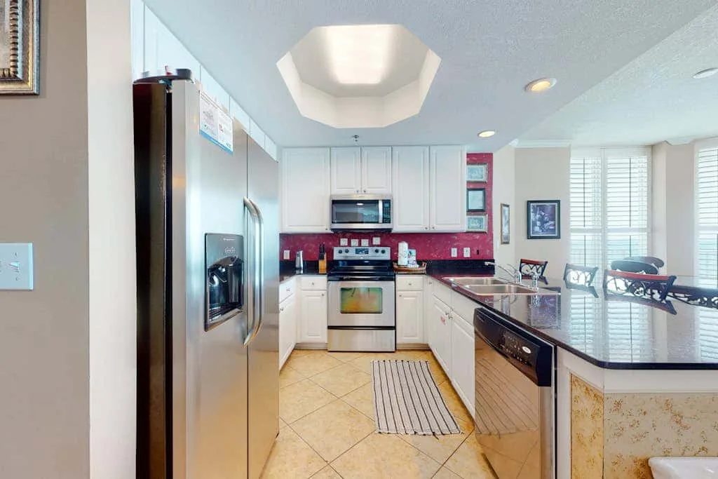 A bright kitchen with stainless steel appliances and a central island.