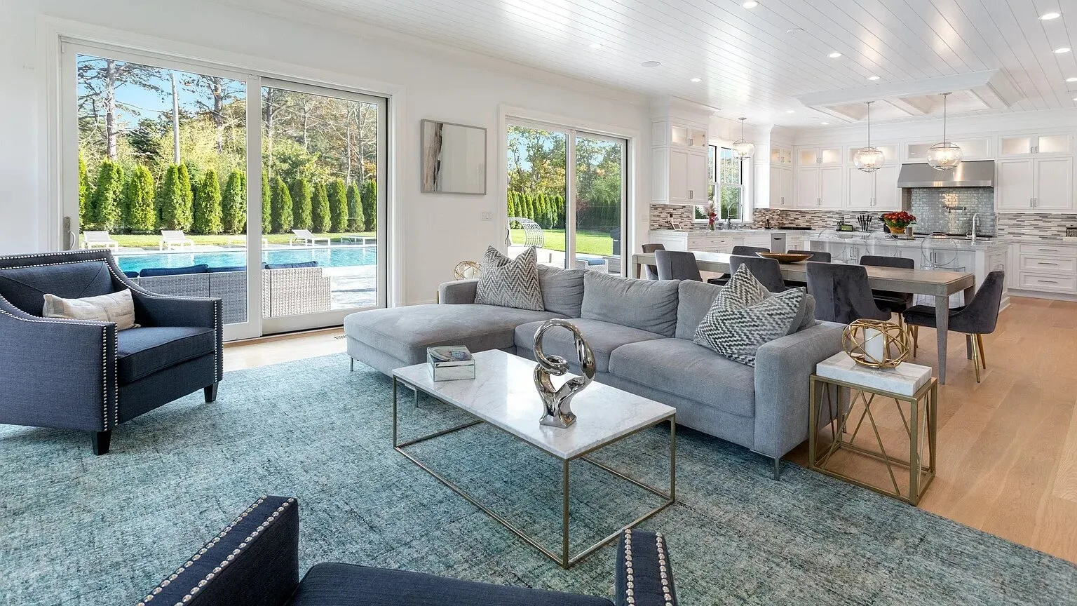 A bright open-plan living and dining area with seating and a table.