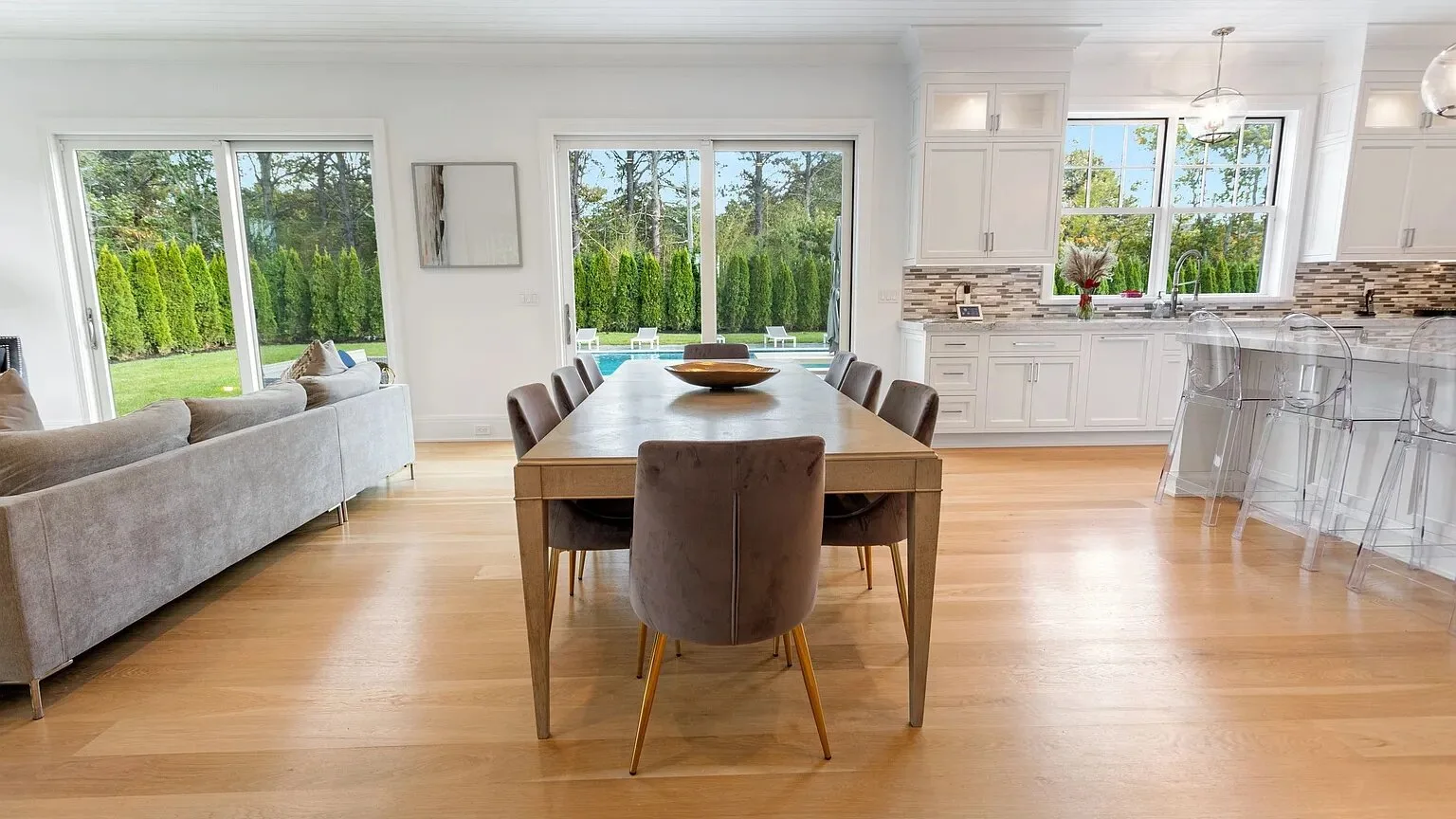 An open-plan living, dining, and kitchen area with a dining table in the center.