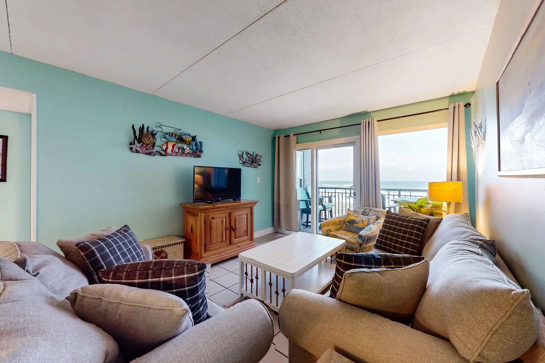 Living room with seating around a coffee table and a view of the water.