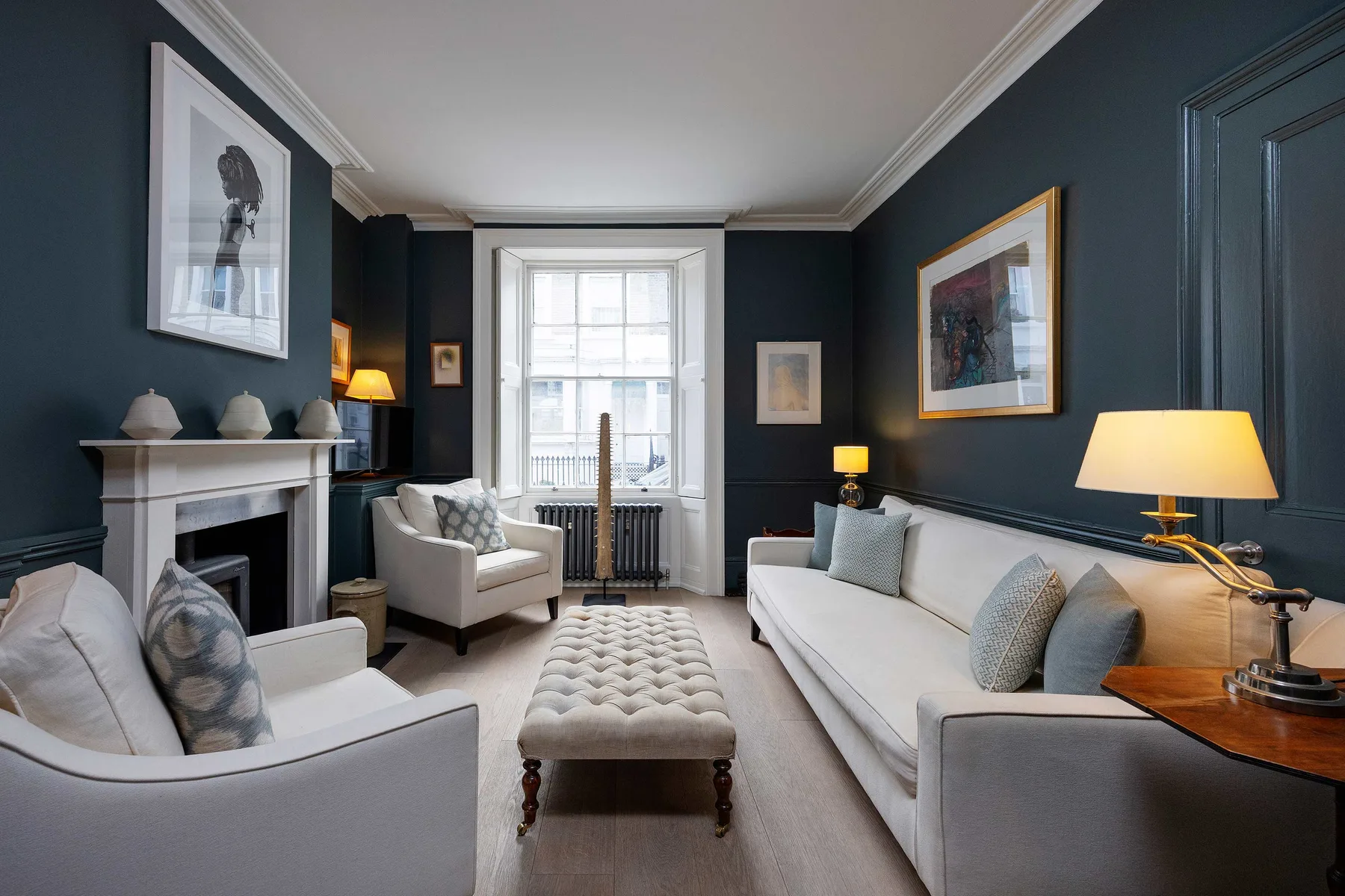 A living room with seating arranged around a central upholstered bench.