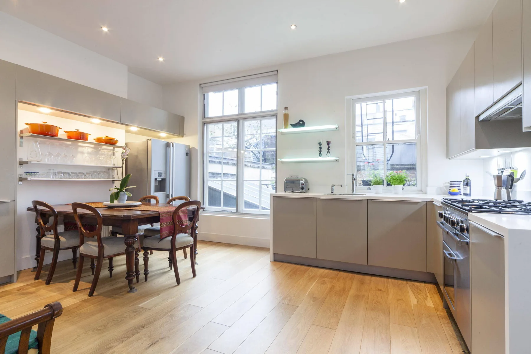 A bright kitchen with a dining table beside the cooking area.