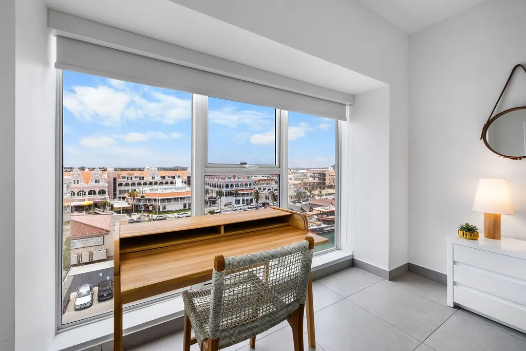 Work comfortably at the desk positioned by the glass windows, where you can enjoy beautiful views and plenty of natural light while staying productive.