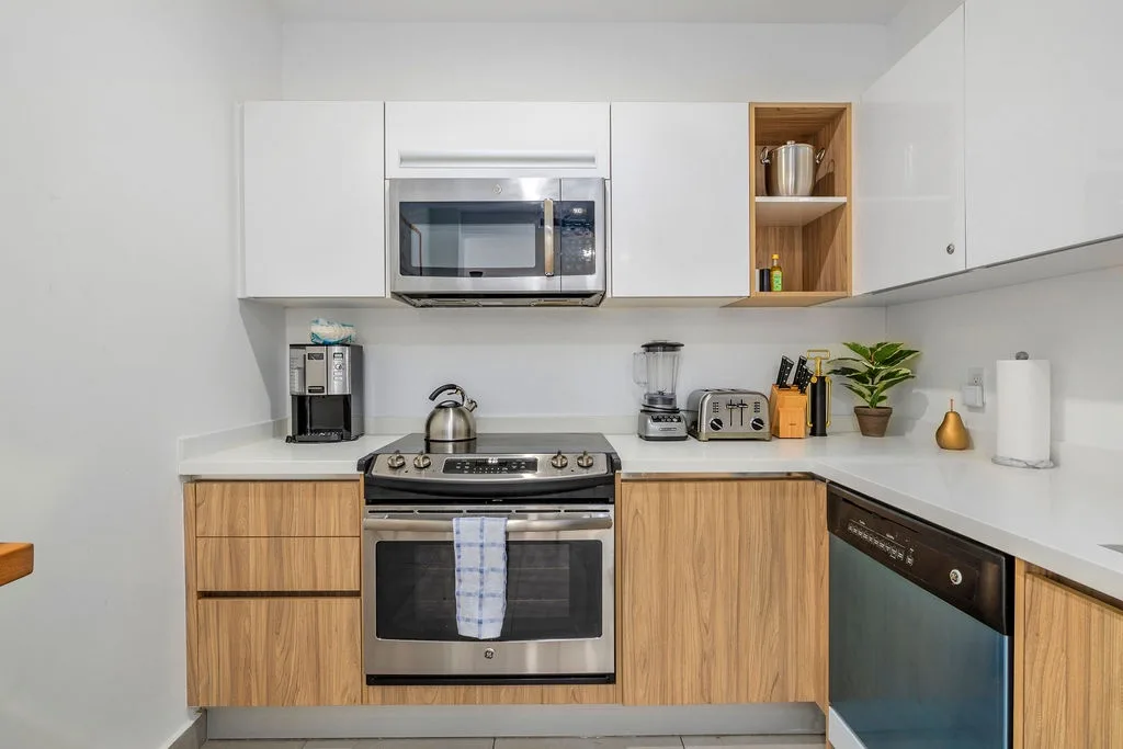 Your sleek kitchen awaits with modern appliances and warm wood accents, perfect for preparing memorable meals during your stay.