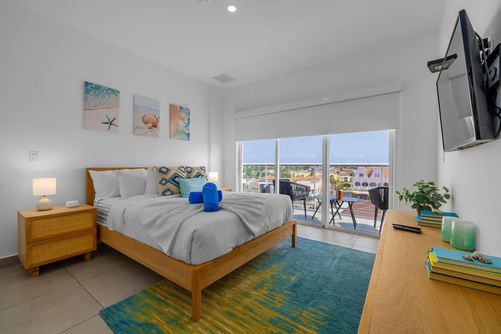 Drift into restful sleep in this bright, coastal-inspired bedroom with a plush Queen bed, beach artwork, and a calming palette. Fresh, modern, and perfect for your getaway.