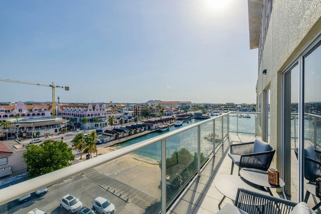 Relax on your private balcony with stunning harbor views, watching boats glide by as you sip morning coffee in comfortable seating.