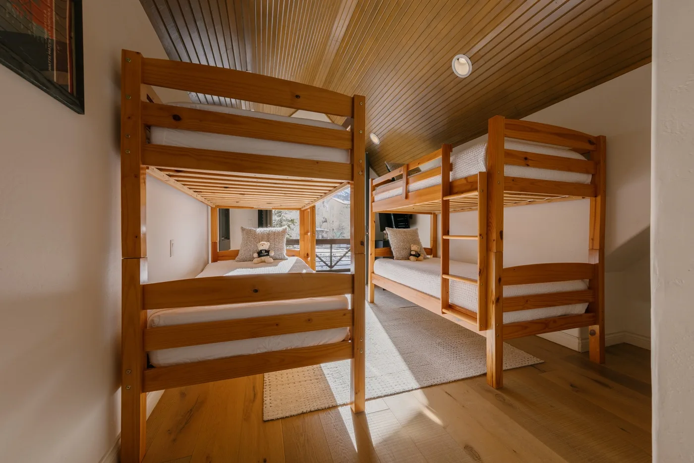 A bunk-bed sleeping area with wooden beds and a low, sloped ceiling.