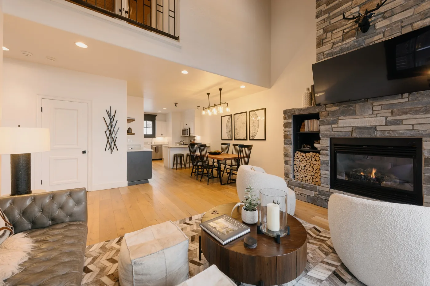An open-plan living and dining area with a fireplace and kitchen.