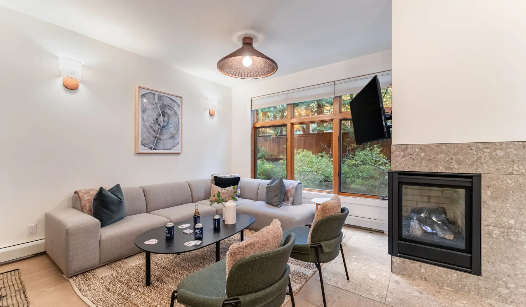 Una sala de estar con asientos seccionales, mesa de centro y chimenea.